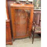 An early 20th century walnut display cabinet