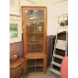 A full height oak glazed display cabinet