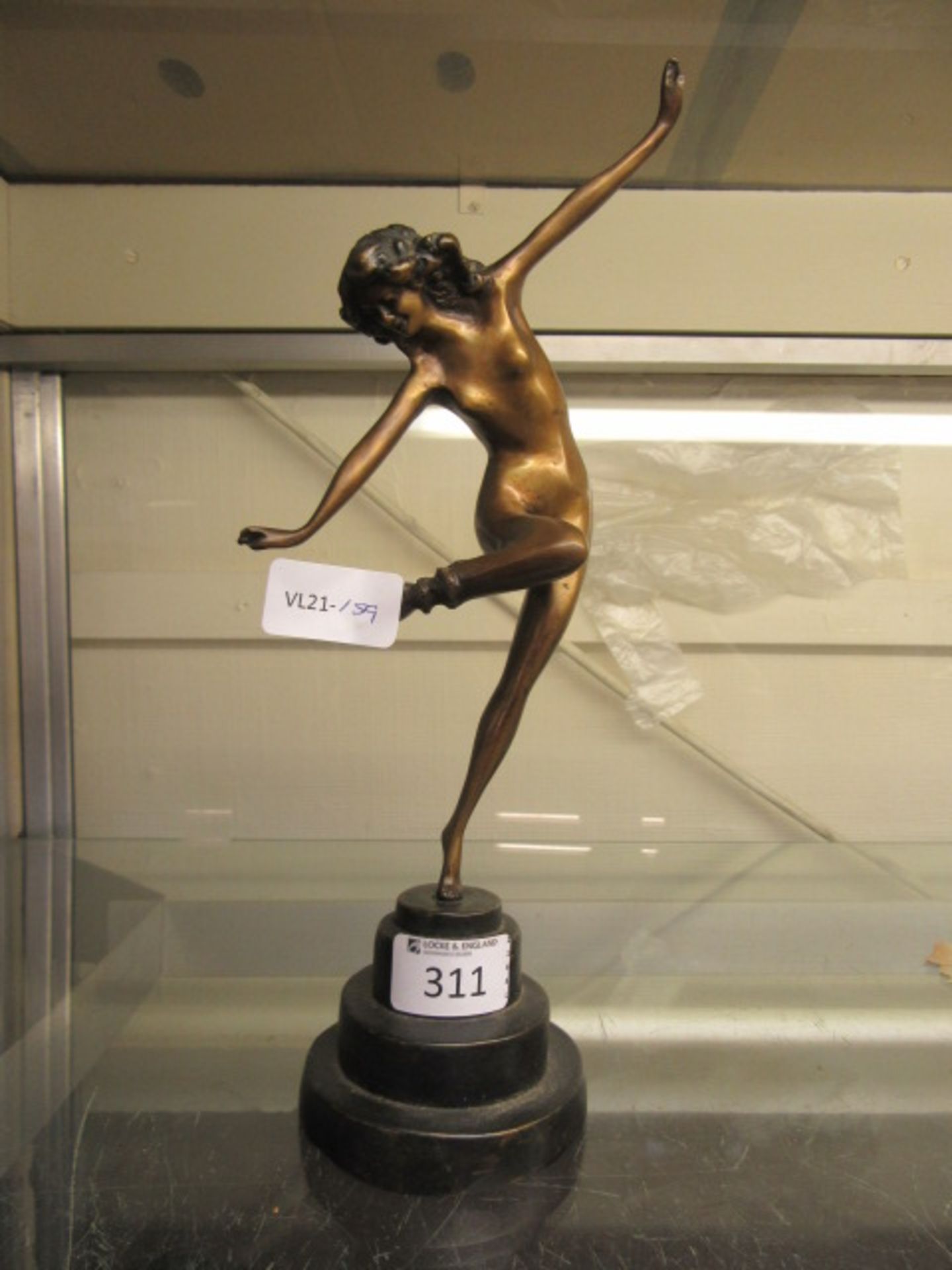 A modern art deco style bronze figure of a lady