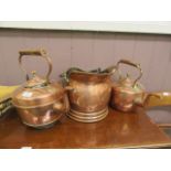 Two brass and copper kettles together with a copper coal scuttles