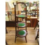 An early 20th century mahogany folding three tier cake stand