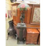 A Tiffany style lamp of young lovers on a columned plinth