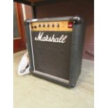 A Marshall Lead 12 amplifier with a microphone, a clip-on microphone,