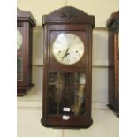 A mid-20th century oak cased drop dial wall clock