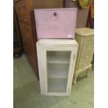 A white painted glazed door cabinet together with a pink painted medicine cabinet