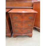 A reproduction burr elm serpentine fronted chest of three drawers of small proportions