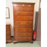 A reproduction burr elm chest on chest consisting of two short over three long drawers to top,