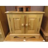 A waxed pine two door cabinet