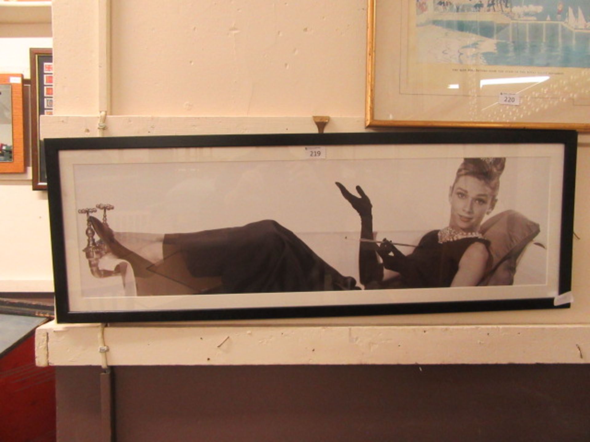 A modern framed and glazed photograph of a lady with a cigarette