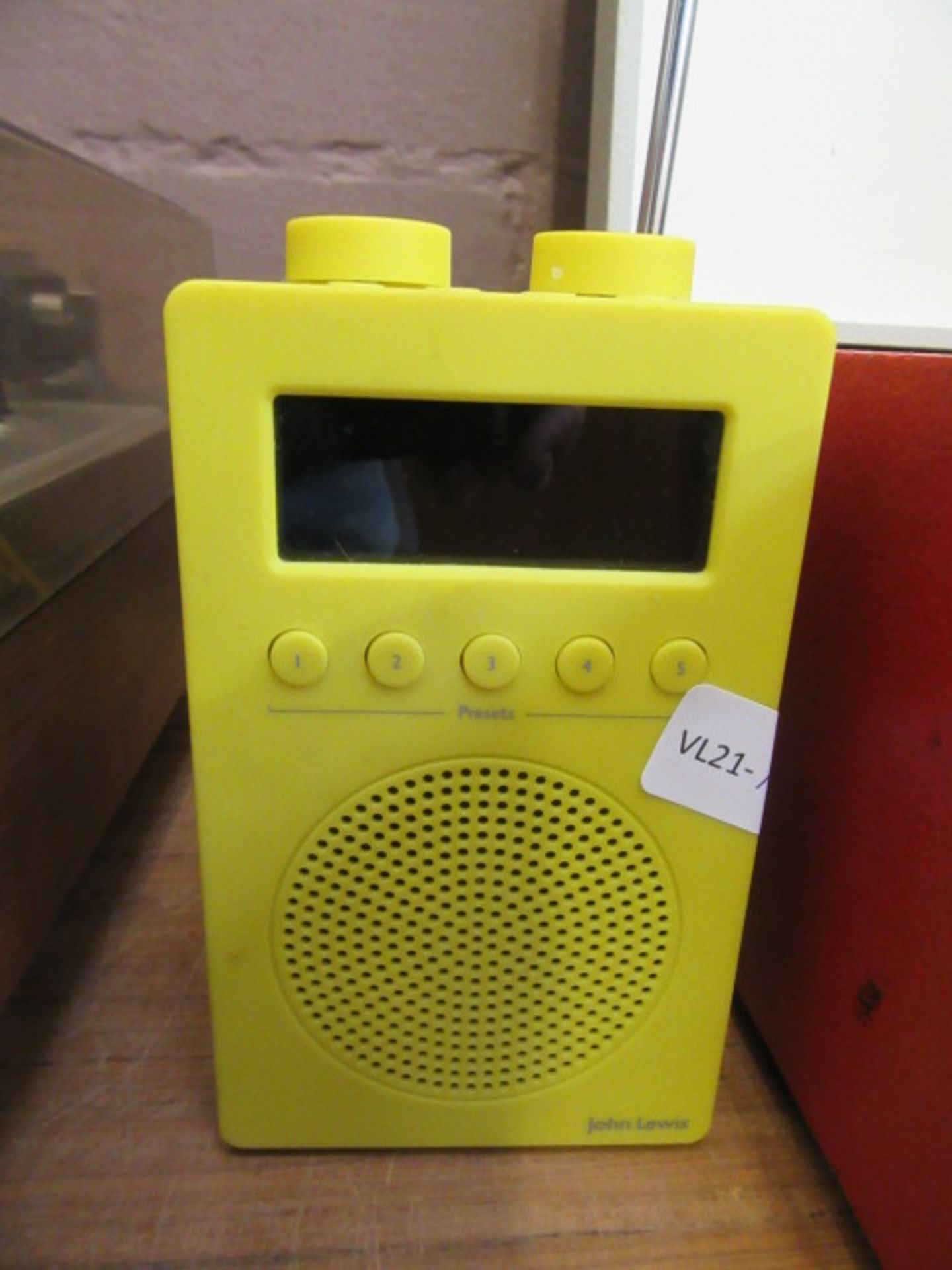 A yellow John Lewis radio alarm clock