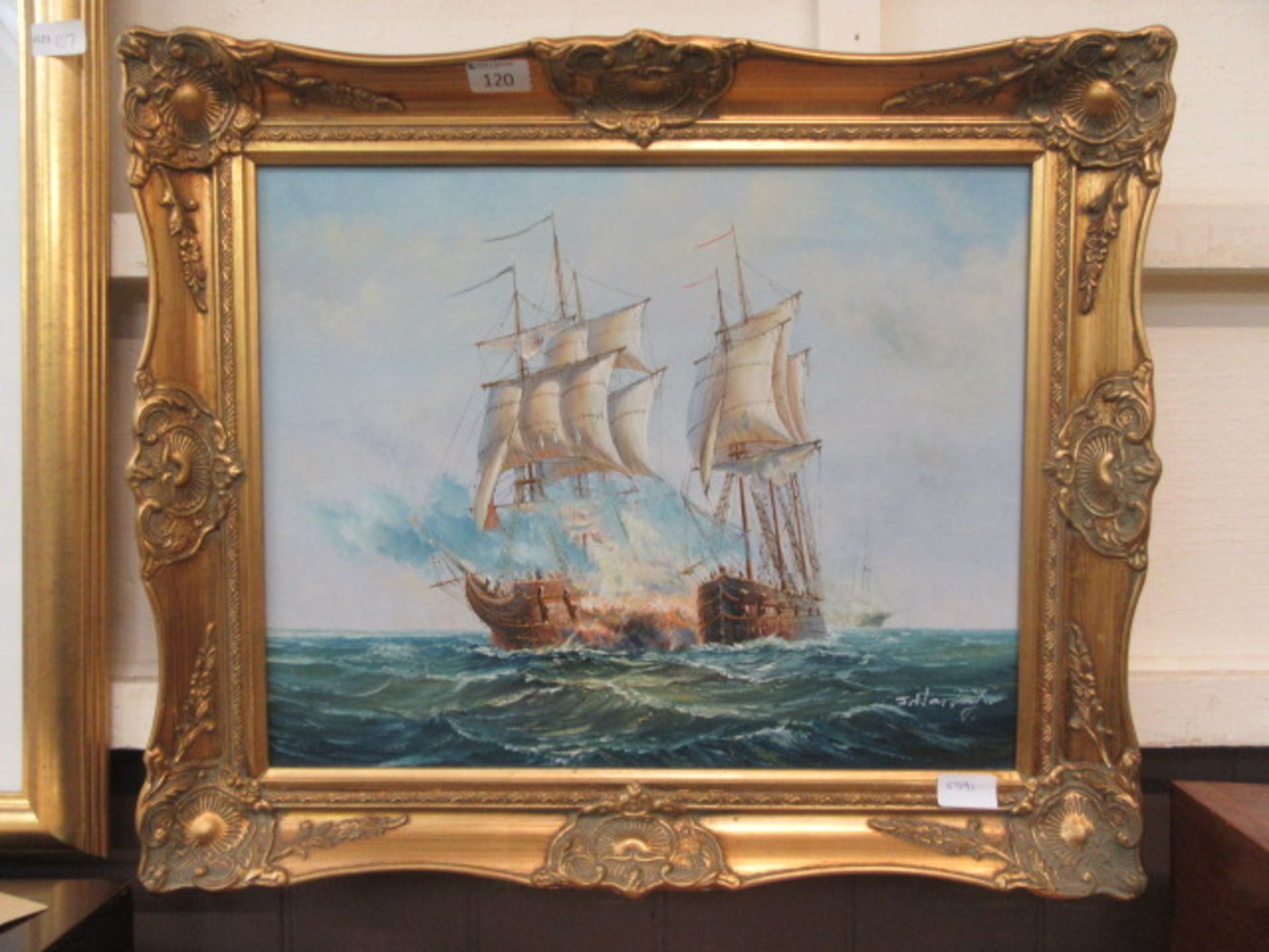 An ornate gilt frame oil on canvas of galleons signed bottom right