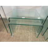 A nest of two bent glass occasional tables