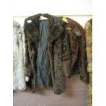 Two dark brown fur coats