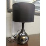 A modern table lamp with bulbous column