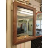 A padded leather framed mirror