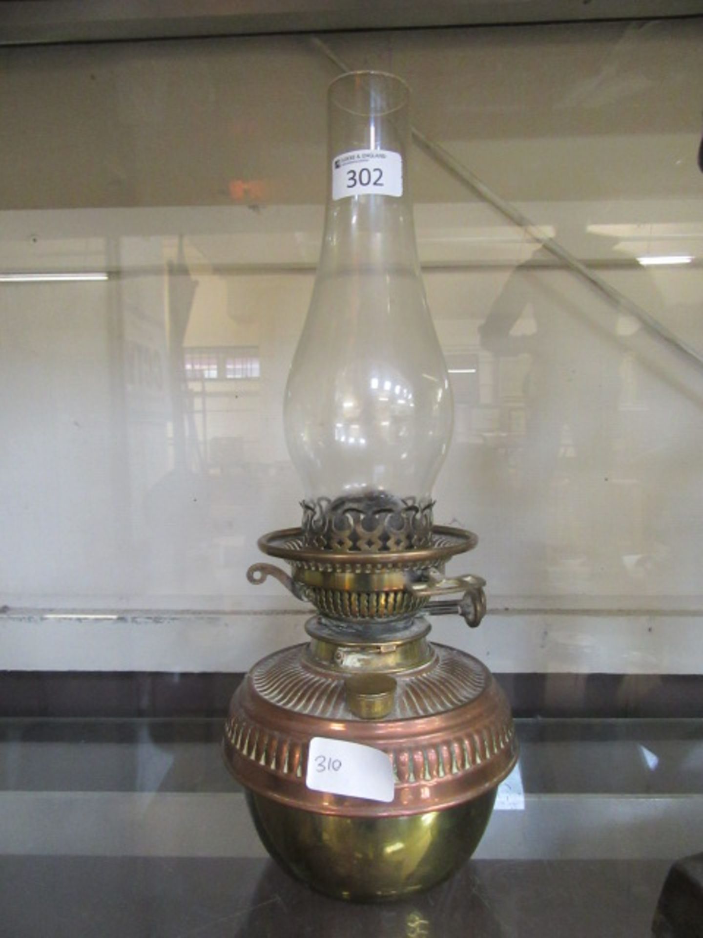 A brass and copper oil lamp