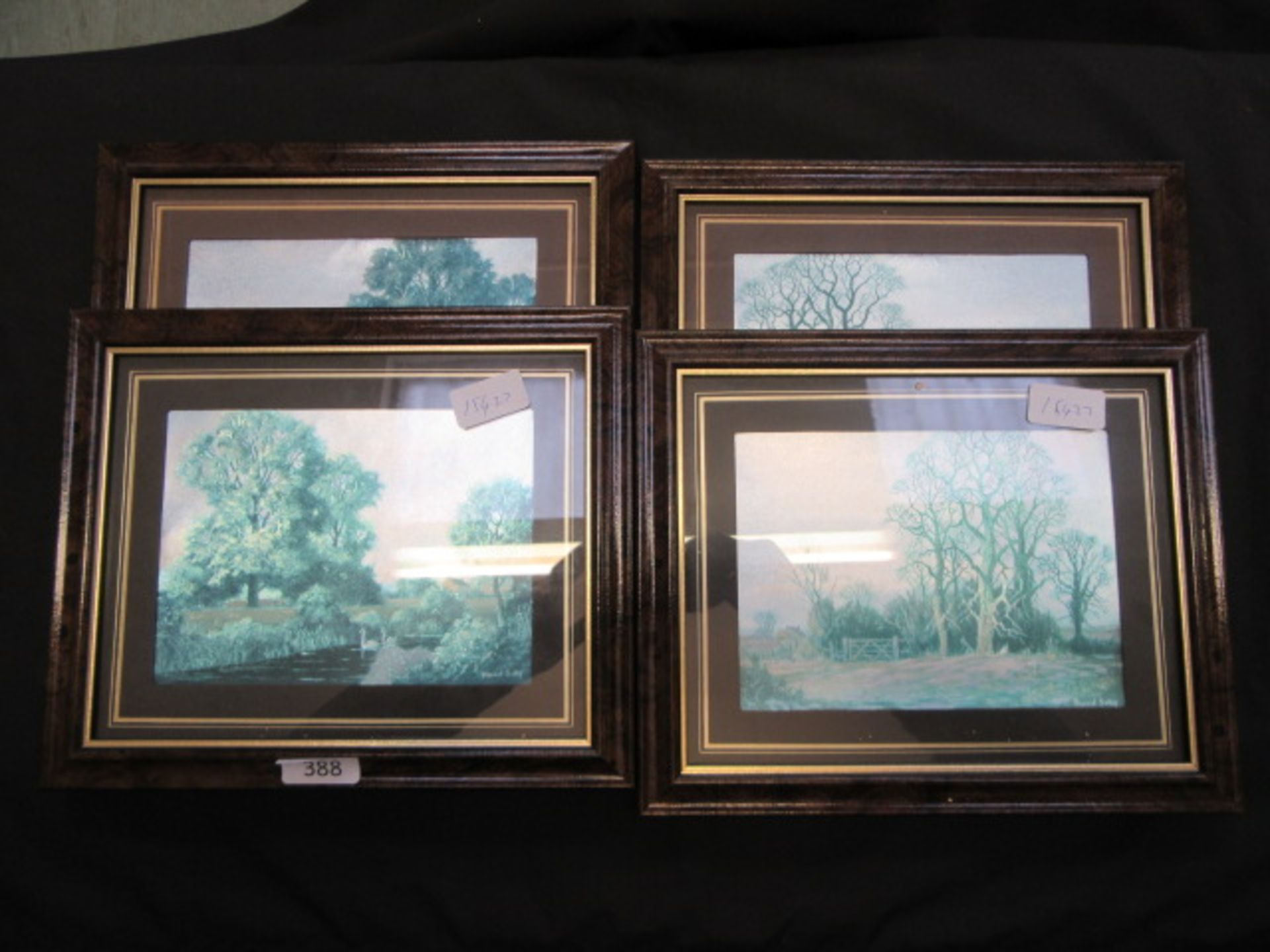 A set of four modern framed and glazed silvered country prints