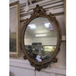 A modern moulded ornate framed mirror