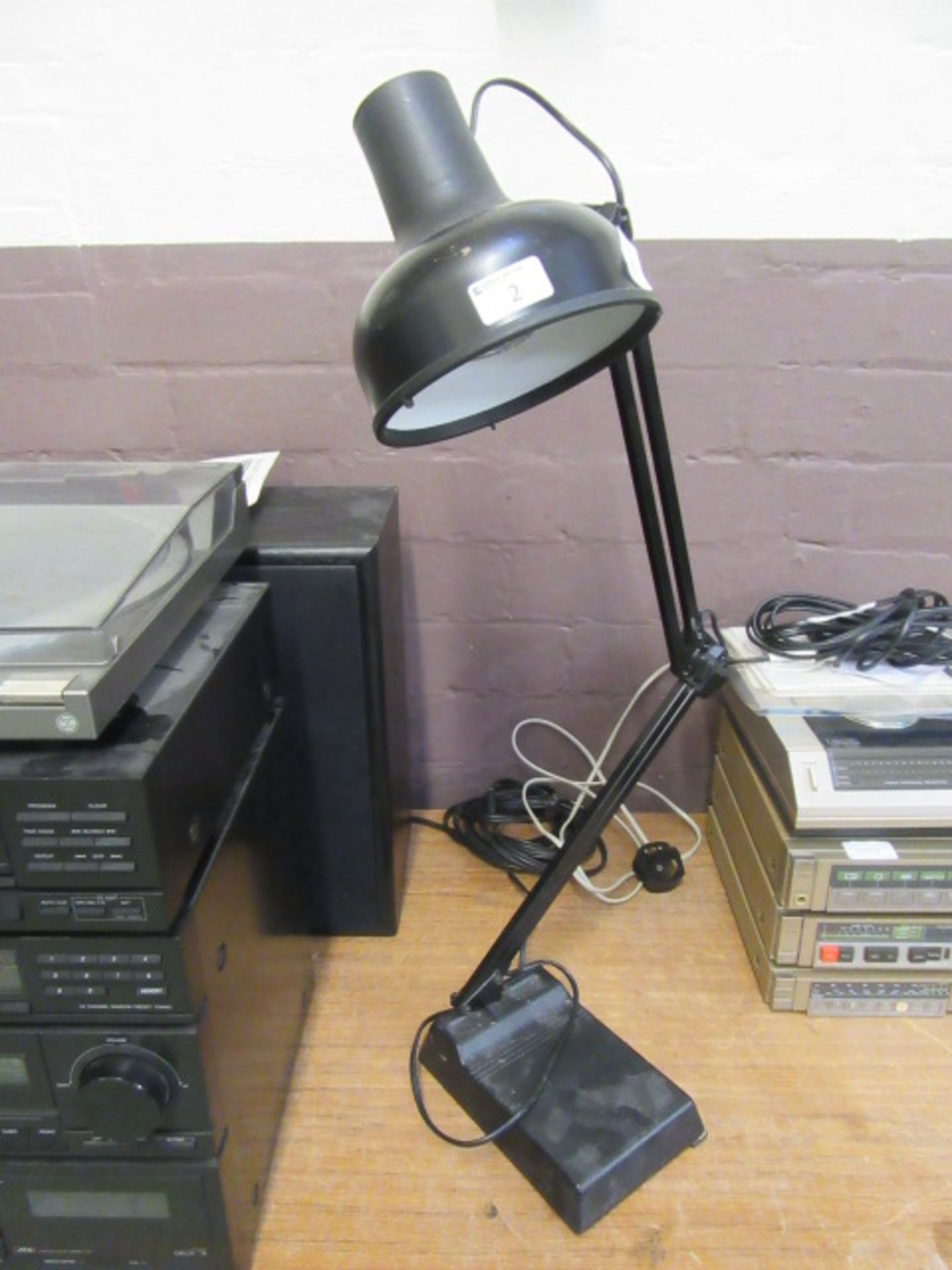 A black angle-poise style lamp