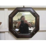 An early 20th century oak octagonal bevel glass mirror