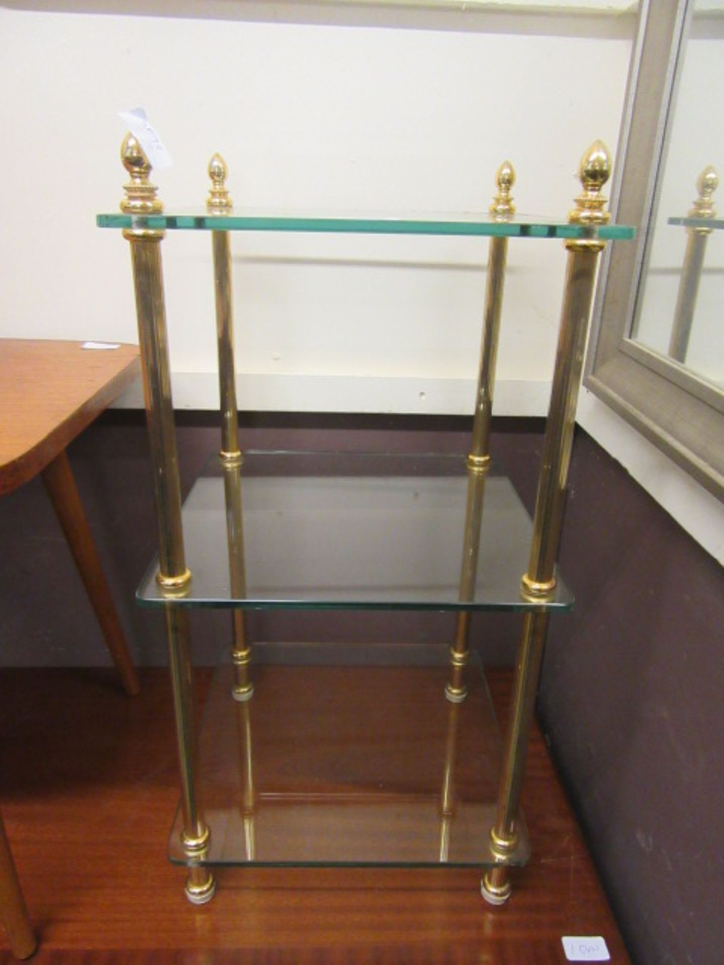 A modern three tier glass and gilt metal stand