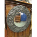 An early 20th century embossed pewter framed circular mirror