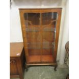 An early 20th century walnut display cabinet