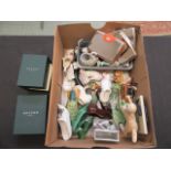A tray containing small ceramic boots, figurines,