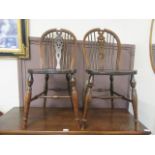 A pair of beech and elm wheel back kitchen chairs