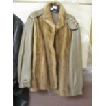 A brown fur and leather coat