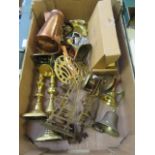 A tray of assorted brass and copperware to include candlesticks, bells, coffee pot,