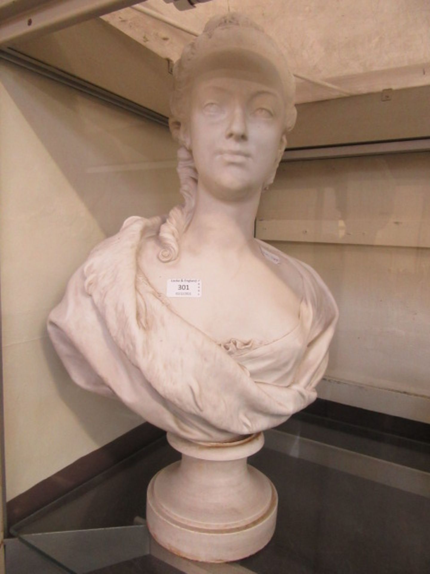 A plaster moulded bust of a young lady