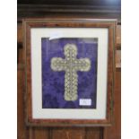 A framed display of the crucifix in lacework