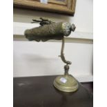 An early 20th century embossed brass desk lamp
