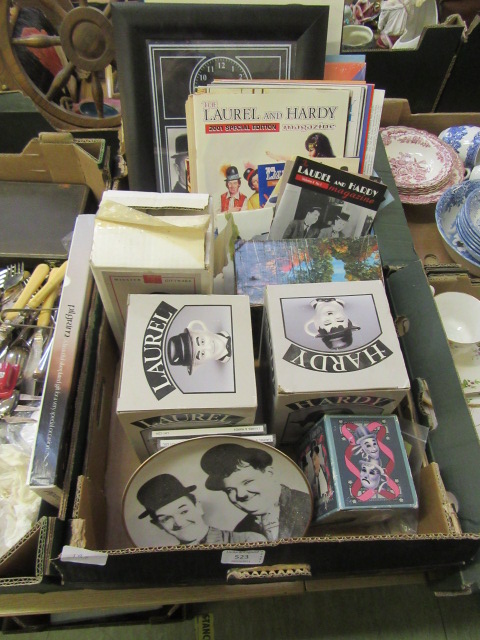 A tray containing a collection of Laurel and Hardy memorabilia to include magazines, posters,