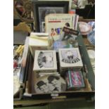 A tray containing a collection of Laurel and Hardy memorabilia to include magazines, posters,