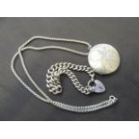 A white metal locket on chain together with a white metal bracelet