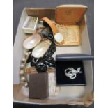 A box containing wrist watches, black beads,