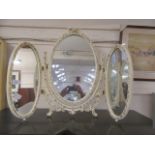 A Queen Anne style cream and gilt decorated vanity mirror