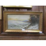 A gilt framed oil on canvas of sheep in snowy field scene signed Oliver