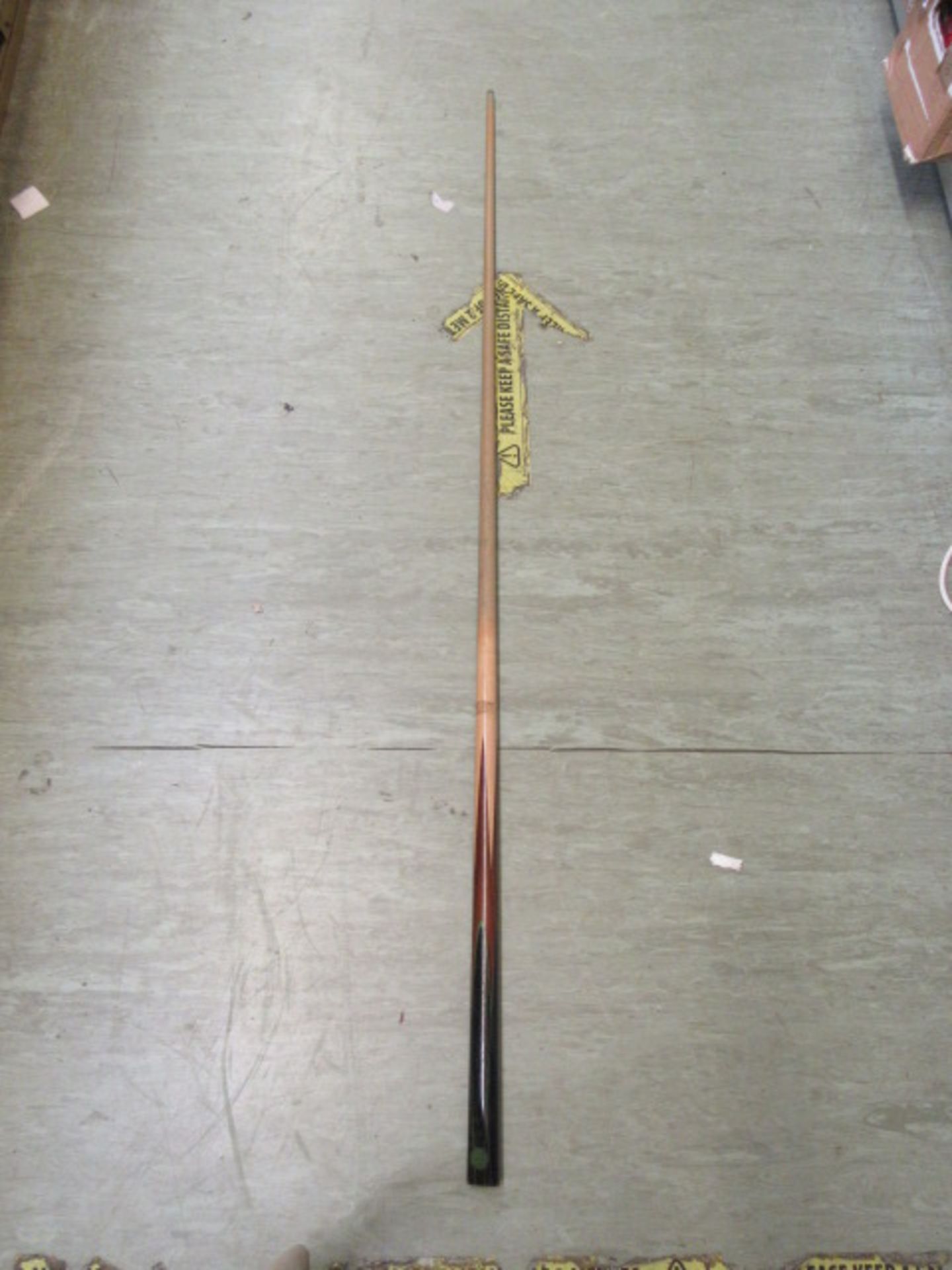 A snooker cue with canvas case CONDITION REPORT: Length : 148cm Plaque near base