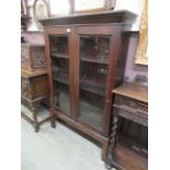 A 19th century oak two door glazed bookcase on stand