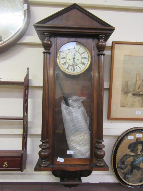 An early 20th century walnut cased Vienna drop-dial wall clock