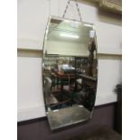 A mid-20th century bevel glass mirror