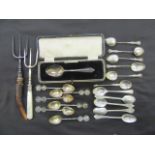 A bag containing an assortment of white metal teaspoons, forks,