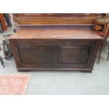 A 19th century oak coffer with carved panelled front