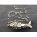 A bag containing a white metal articulated fish