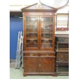 A reproduction burr elm 18th century style bookcase, the pediment over two astregal glazed doors,