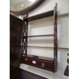 A reproduction set of wall shelves with drawer