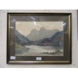 A framed and glazed watercolour of lake in mountain scene signed E.